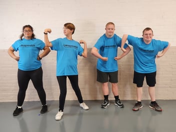 Four young adults with intellectual disabilities pose for a fun photo