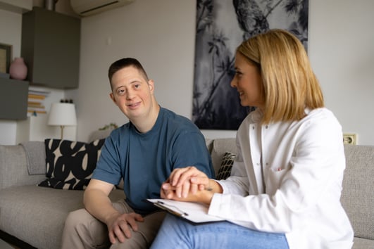 woman working with young man with down syndrome